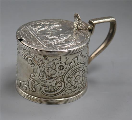 A George III silver mustard pot with later? embossed decoration.